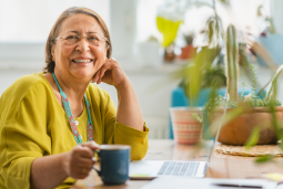 Member resouces CTA Woman smiling while sitting at desk