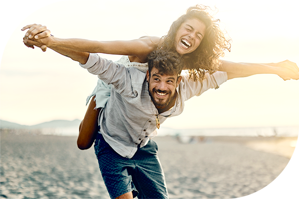 MVPBlog0006_Lifestyle Medicine_Header Couple enjoying time together at the beach, one person giving the other a piggyback ride
