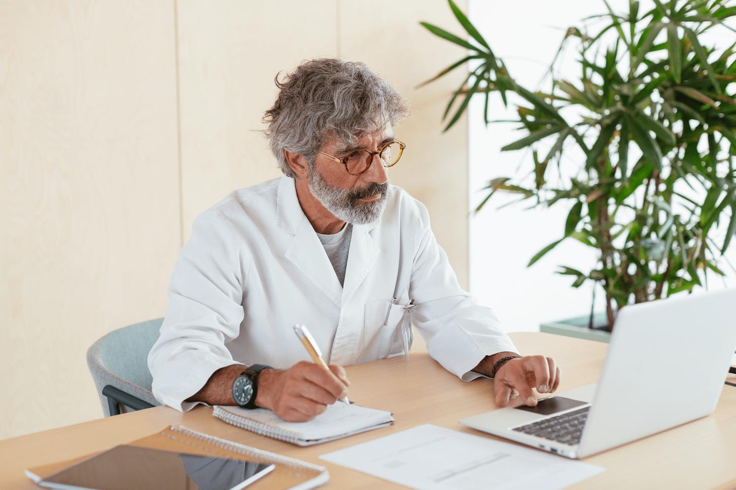 doctor taking notes at desk