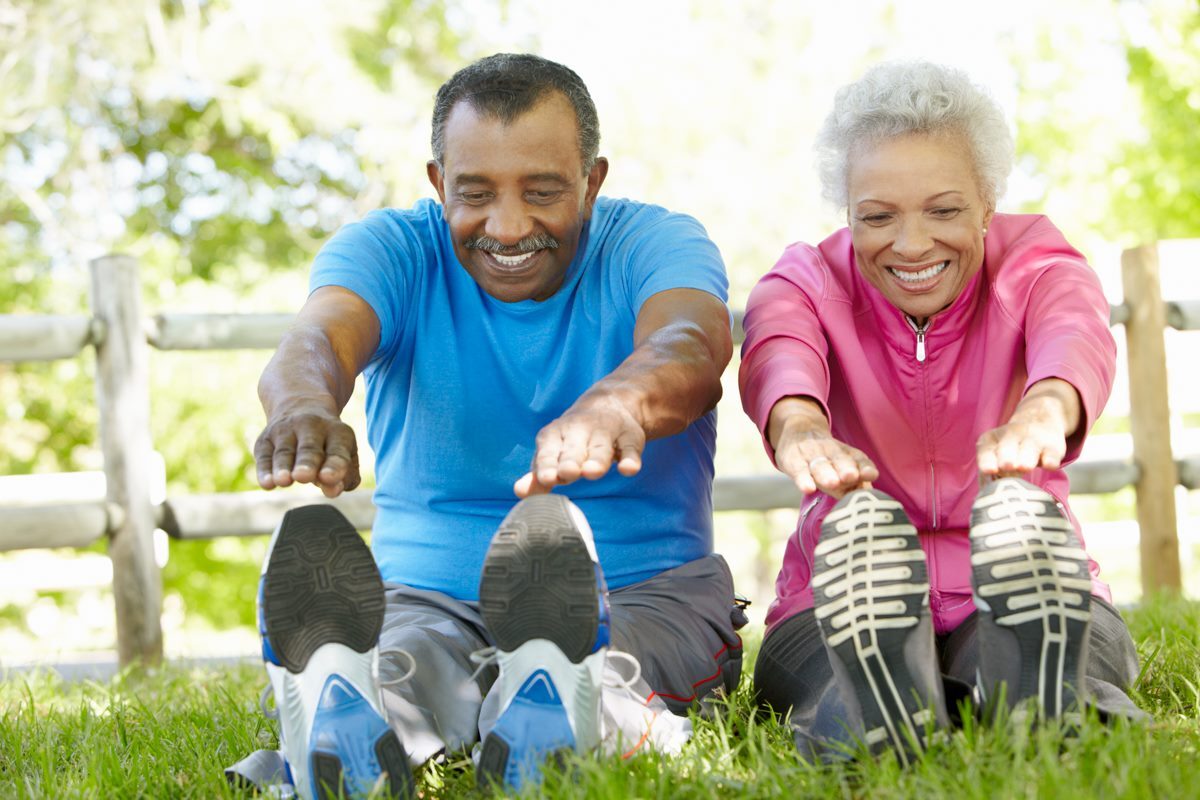 old people stretching together before exercise