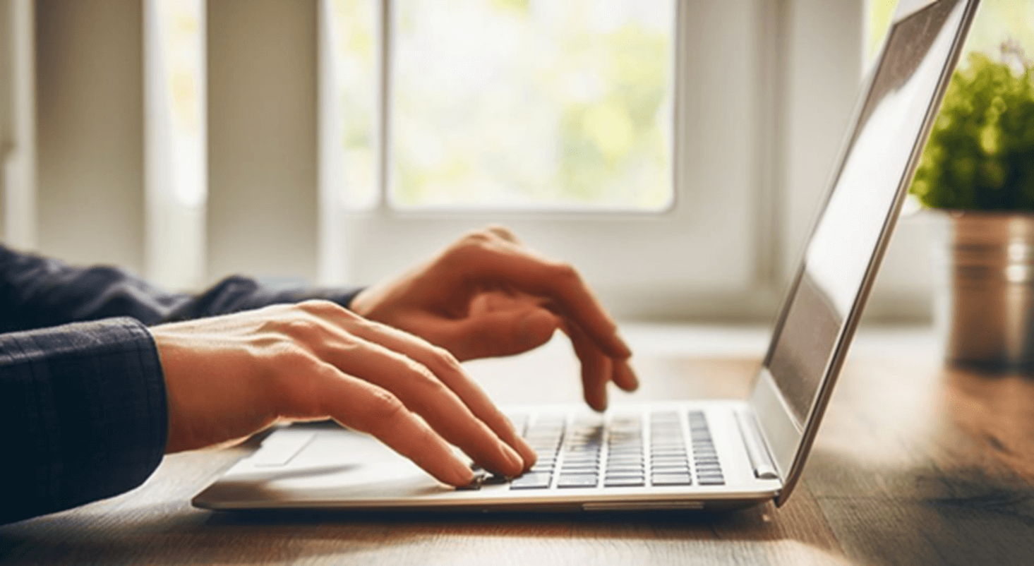 hands typing on laptop