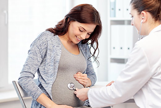 doctor checking belly of a pregnant patient