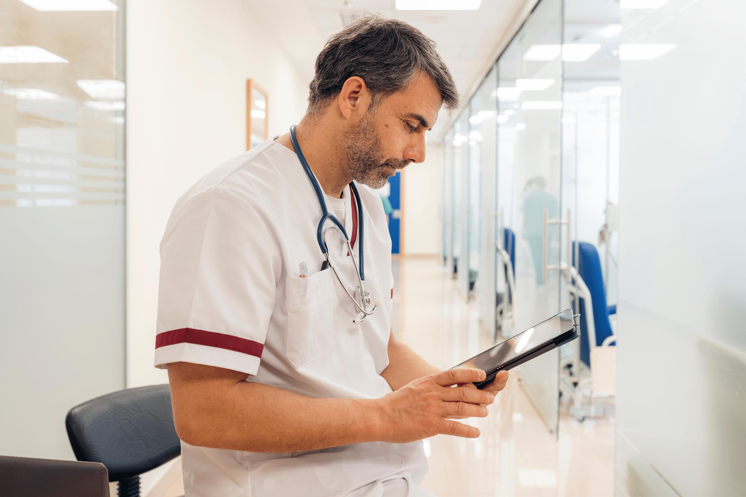 provider in scrubs looking at tablet