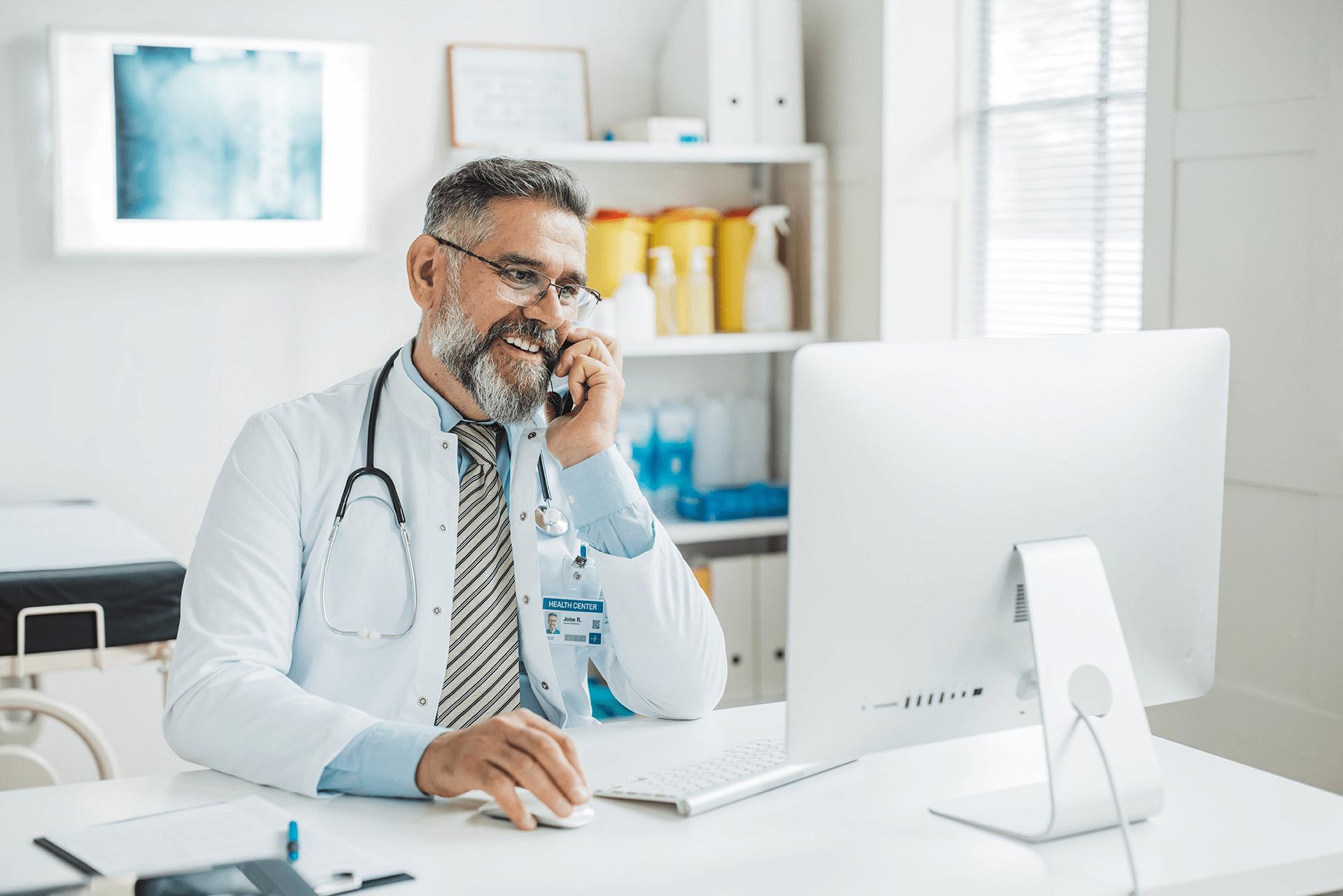 provider on phone at computer desk